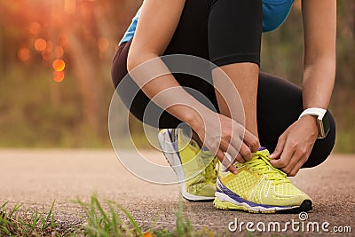 Woman tying sport shoes Stock Photo