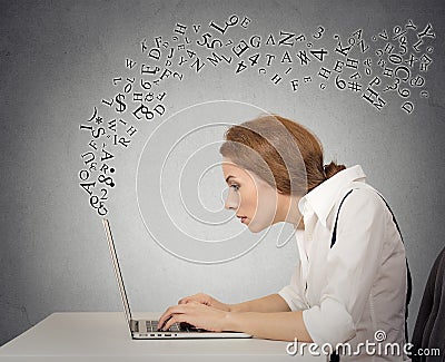 Woman typing on her laptop computer with alphabet letters flying Stock Photo