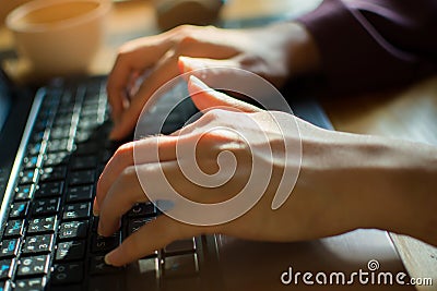 A woman is typing on the keyboard to send a message Stock Photo