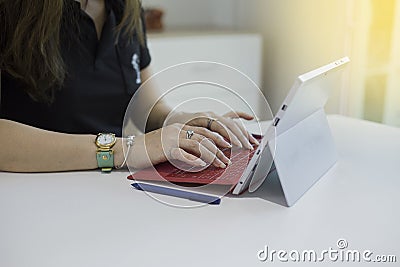 Woman typing text or words on tablet computer keyboards Stock Photo