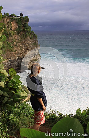 Woman at Uluwatu Bali looking at waves and ocean Editorial Stock Photo