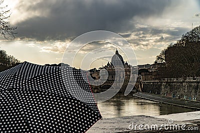 Woman with umbrella in front of the Papal Basilica of St. Peter, west of River Tiber in Rome, Italy Stock Photo