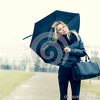 Woman with umbrella in rainy weather Stock Photo