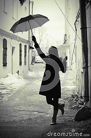 Woman with umbrella retro in old city Stock Photo