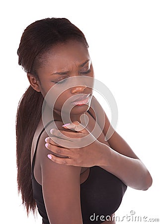 Woman in undergarments suffering from shoulderache Stock Photo