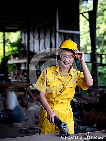 A woman in a uniform working in a technician is preparing to use the tools Stock Photo