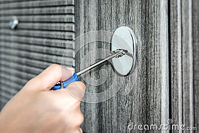 Woman unlocking door with key, closeup view Stock Photo