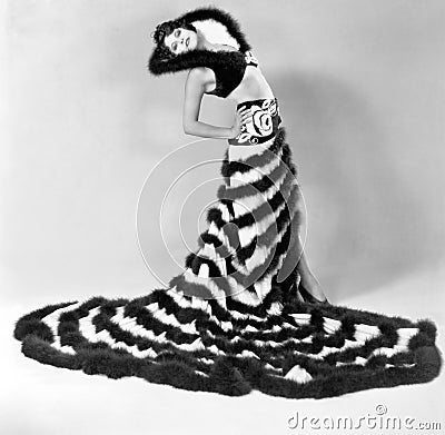 Woman in an unusual dress with stripes of fur Stock Photo