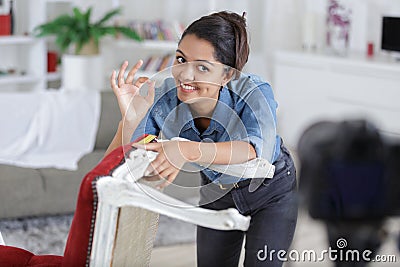 woman upholstering chair in workshop Stock Photo