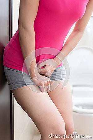 Woman urine urgency Stock Photo