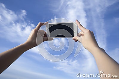 Woman use smart phone take a photo of blue sky and beautiful cloud , isolate black monitor Stock Photo