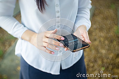 Woman use smartphone at home. Progress Bar Loading with the text: Jesus on smartphone screen. Church online concept Stock Photo