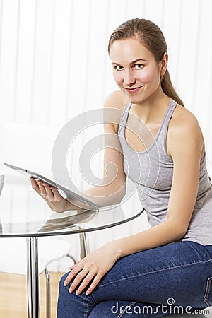 Woman use tablet in the kitchen Stock Photo