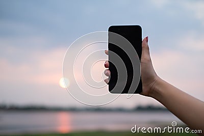 Woman uses she Mobile Phone outdoor, close up Stock Photo