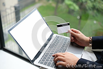 woman uses smart tablet computer and holds credit card with online shopping. Stock Photo