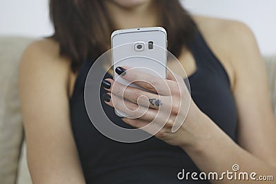 Woman usign new mobile phone with one hand Stock Photo