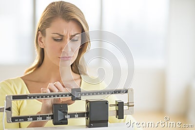 Woman Using Balance Weight Scale At Gym Stock Photo