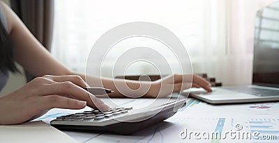 Woman using calculator for calaulating finance, tax, accounting, statistics and analytic reserch concept Stock Photo