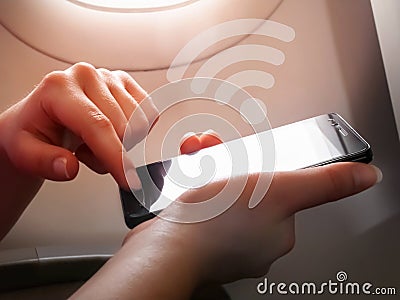 Woman hand using smart phone on the airplane, wifi Stock Photo