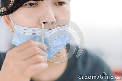 Woman using covid-19 rapid antigen self test kit at home with a cotton nasal swab Stock Photo