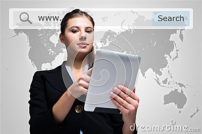 Woman using a digital tablet in front of a world map Stock Photo