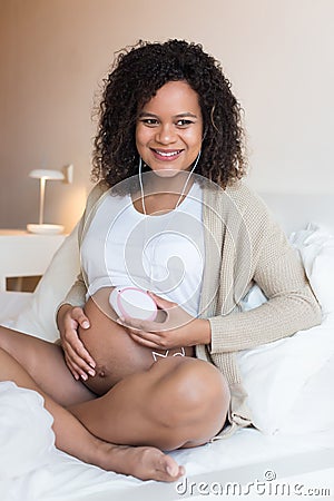 Woman using a fetal doppler at home Stock Photo