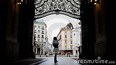 Woman using gadget in hofburg Vienna, silhouette, wide angle Stock Photo