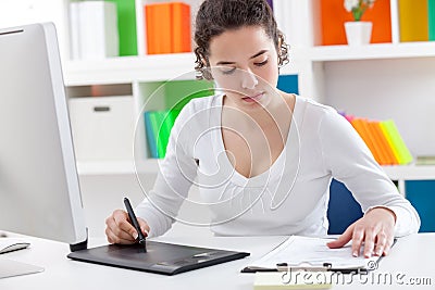 Woman using a graphic tablet and pen Stock Photo