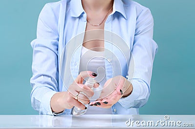 Woman using hand antibacterial spray.Girl wipes hands with sanitizer,desinfectant.Coronavirus protection Stock Photo