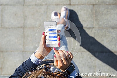 Woman using instant messaging app on mobile phone Stock Photo