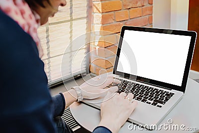 Woman using laptop with blank screen on table Editorial Stock Photo