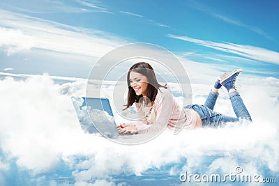 Woman using Laptop on Cloud. Happy Young Girl typing on Computer Lying Down. Cloud Technology Internet Information Data Concept Stock Photo