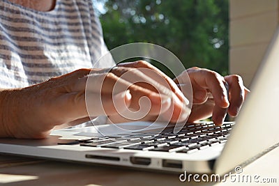 Woman using a laptop computer, close-up of hands Stock Photo