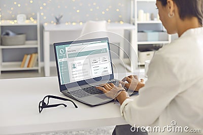 Woman using laptop computer, managing her bank account and transferring money online Stock Photo