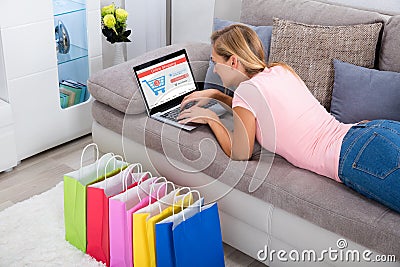 Woman Using Laptop For Online Shopping At Home Stock Photo