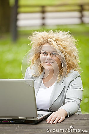 Woman using laptop in open office Stock Photo