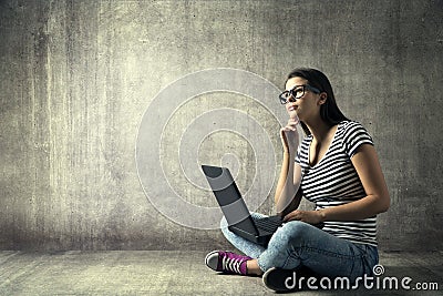 Woman Using Laptop, Young Girl in Glasses Thinking on Notebook Stock Photo