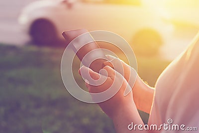 Woman using mobile phone app to call taxi cab Stock Photo