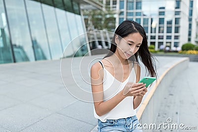 Woman using mobile phone in the city Stock Photo