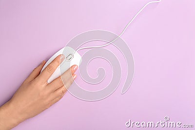Woman using modern wired optical mouse on background, top view. Space for text Stock Photo