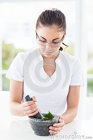 Woman using mortar and pestle Stock Photo