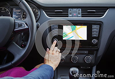 Woman using navigation system while driving a car Stock Photo