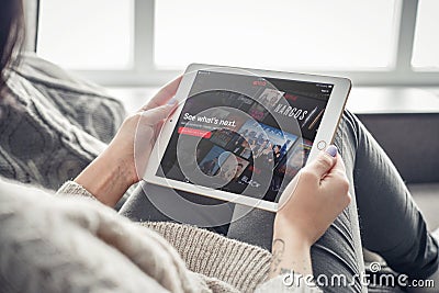 Woman using Netflix app on a brand new Apple iPad Pro Editorial Stock Photo
