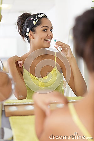 woman using perfume at home Stock Photo