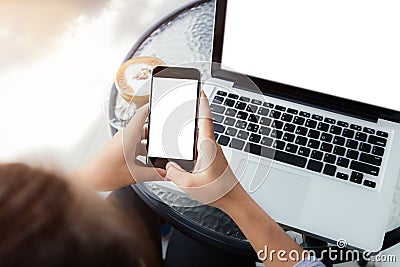 Woman using phone on work table Stock Photo