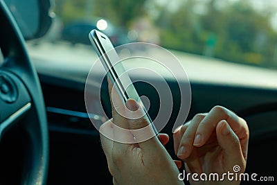 Woman using smart phone on the car Stock Photo