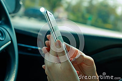 Woman using smart phone on the car Editorial Stock Photo