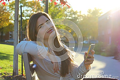 Woman using smart phone, outdoors Stock Photo