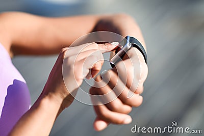 Woman using smartwatch touching touchscreen Stock Photo