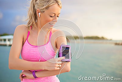 Woman using sports tracking mobile app on her smartphone Stock Photo